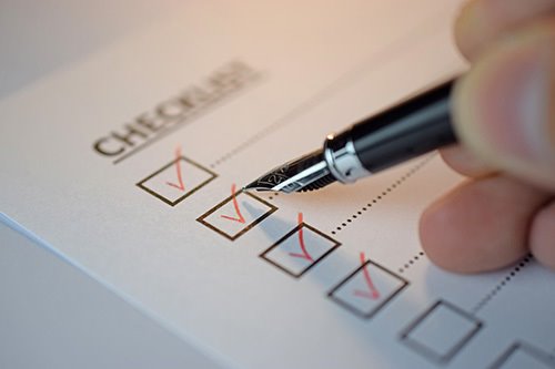 A list with checkboxes being marked in red pen