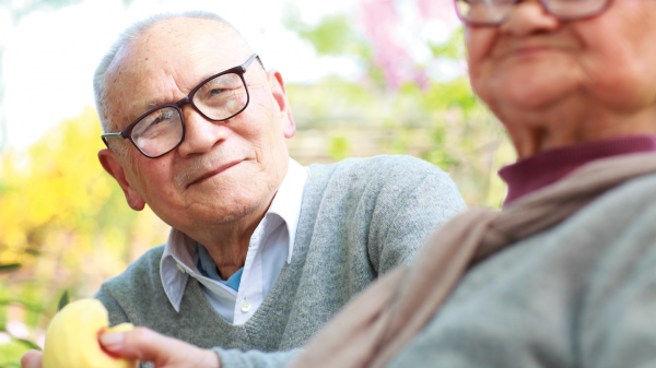 Image of older man spending time with his wife in the garden