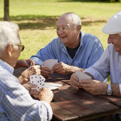 Image group of four elderly men at park bench